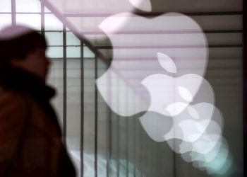 Apple company logos are reflected on the glass window outside an Apple store in Shanghai, China January 3, 2019. REUTERS