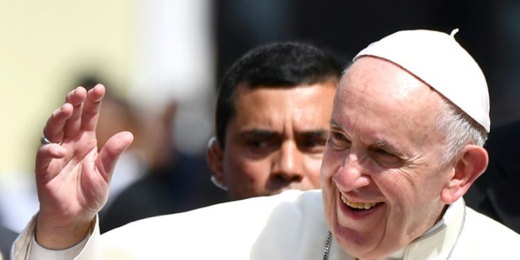 Pope Francis waves after a meeting with Central American bishops in which he blasted "fears and suspicions" over migration