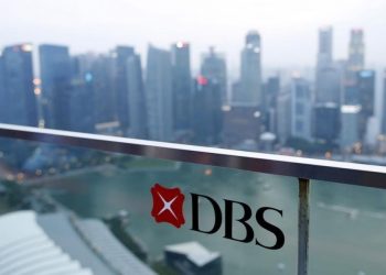 A DBS logo in pictured in the backdrop of the central business district in Singapore (Reuters)