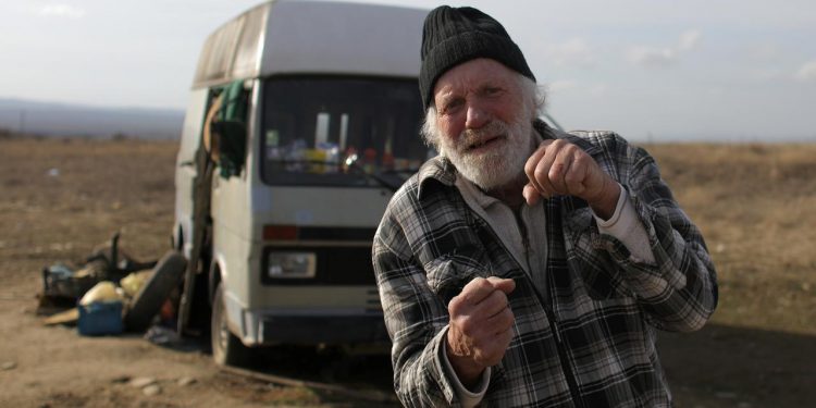 Former Dutch boxer Rudi Lubbers poses in front of the van where he and his partner were living for the last eight months, near the village of Kosharitsa, Bulgaria