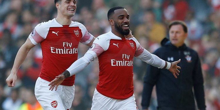 Arsenal’s Alexandre Lacazette (R) and Granit Xhaka races away in delight after scoring against Southampton, Sunday