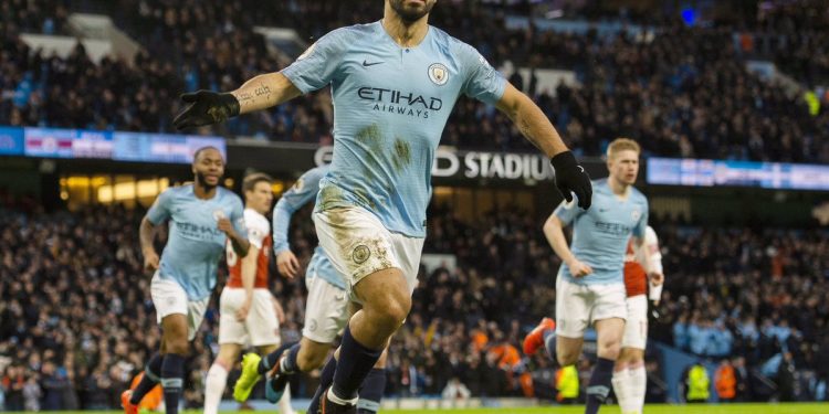 Manchester City’s Sergio Aguero wheels away in celebration after scoring one of his three goals against Arsenal, Sunday 