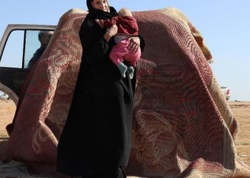 Leonora awaits to be screened and registered by the SDF in the countryside of the eastern Syrian Deir Ezzor province January 31