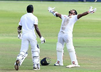 Kusal Perera stretches his arms and looks skyward after taking Sri Lanka to a one-wicket win at Durban as Viswa Fernando joins him for celebration, Saturday