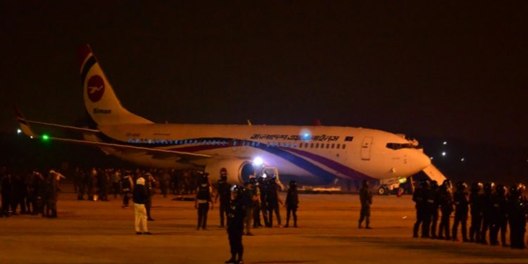 Bangladeshi security personnel stand guard near the hijacked Dubai-bound plane. Officials say the would-be hijacker was carrying a toy gun (AFP)