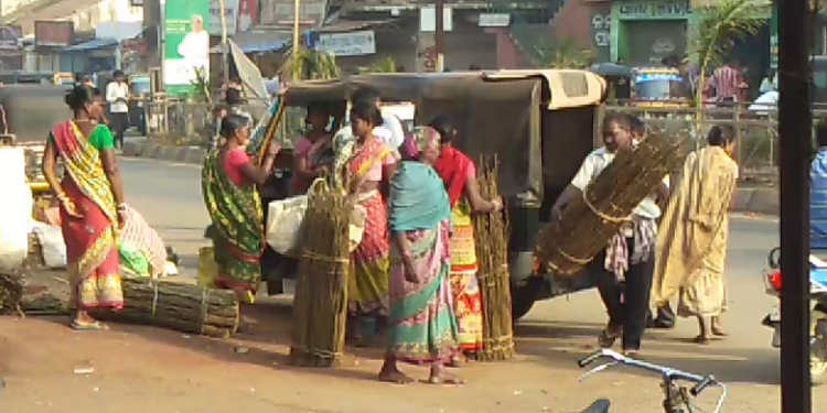 Women carry sal wood to be used for making tooth picks