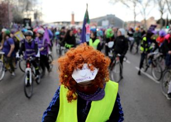 A woman wears a mask that reads ‘Feminist Strike’ as she takes part in a bike protest during a nationwide feminist strike on International Women's Day in Madrid, Spain