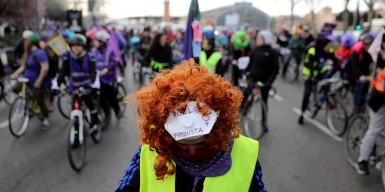 A woman wears a mask that reads ‘Feminist Strike’ as she takes part in a bike protest during a nationwide feminist strike on International Women's Day in Madrid, Spain