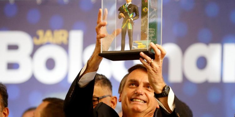 FILE PHOTO: Presidential candidate Jair Bolsonaro, shows a doll of himself during a rally in Curitiba, Brazil March 29, 2018. (REUTERS)