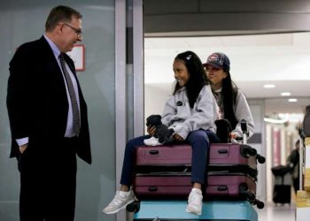 Lawyer Robert Tibbo greets Vanessa Rodel and her daughter Keana as the pair arrive in Canada at the Toronto airport on a flight from Hong Kong on March 25, 2019 (AFP)