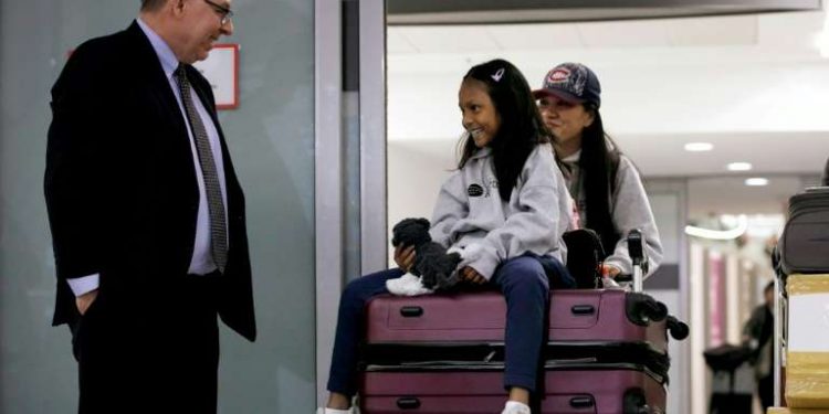 Lawyer Robert Tibbo greets Vanessa Rodel and her daughter Keana as the pair arrive in Canada at the Toronto airport on a flight from Hong Kong on March 25, 2019 (AFP)