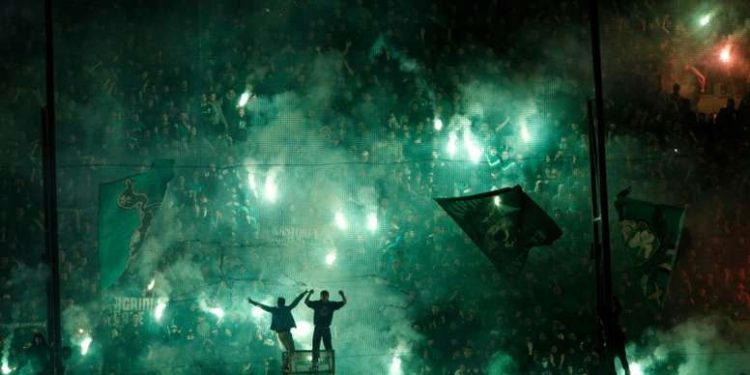 Riot-trained police used tear gas to bring order and to chase away dozens of hooligans who had darted on to the field.