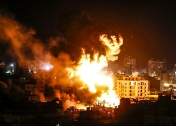 Fire and smoke billow above buildings in Gaza City during reported Israeli strikes March 25, 2019 (AFP)