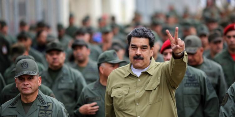 Venezuelan President Nicolas Maduro (showing V sign) has the support of the army