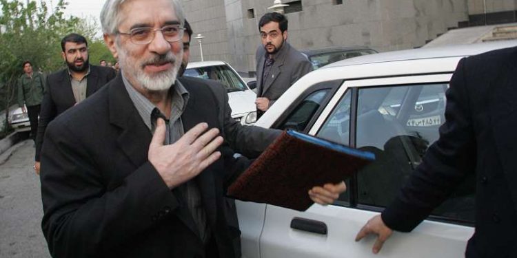 FILE - Mir Hossein Mousavi, Iran's former prime minister and reformist candidate for the Iranian presidential elections, arrives for a meeting with economists in Tehran on April 16, 2009. (AFP)