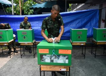 Soldiers cast their ballots in Bangkok. The army has carried out 12 coups in under 90 years (AFP)