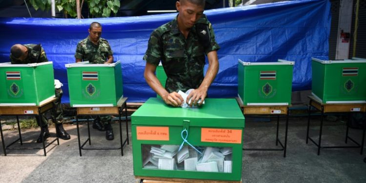 Soldiers cast their ballots in Bangkok. The army has carried out 12 coups in under 90 years (AFP)