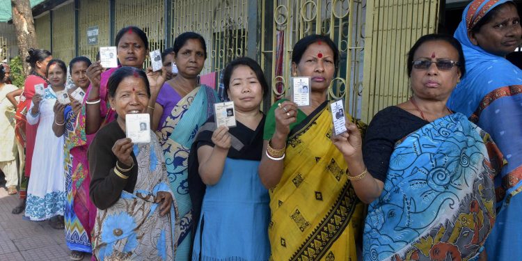 Cooch Behar: People show their voter identity cards before casting their votes during the first phase of the general elections, at a polling station in Cooch Behar, West Bengal, Thursday, April 11, 2019. (PTI Photo)