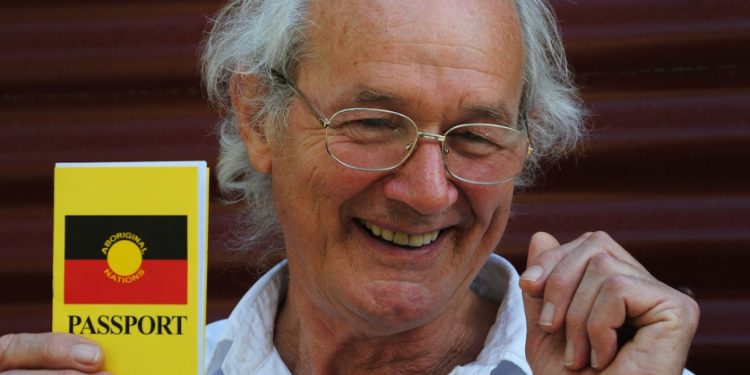 John Shipton, the biological father of Wikileaks founder Julian Assange, holds an Aboriginal Nations passport for use when travelling within Australia which he accepted in Sydney on behalf of his son on September 15, 2012. Shipton said he spoke frequently with his 41-year-old son who won asylum from Ecuador to escape extradition from Britain to Sweden, where he faces sexual assault allegations. (AP photo)