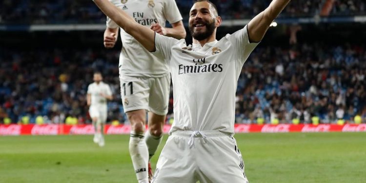 Karim Benzema celebrates after scoring the 89th minute winner for Real Madrid while Gareth Bale (back) joins in against Huesca at Santiago Bernabeu, Monday