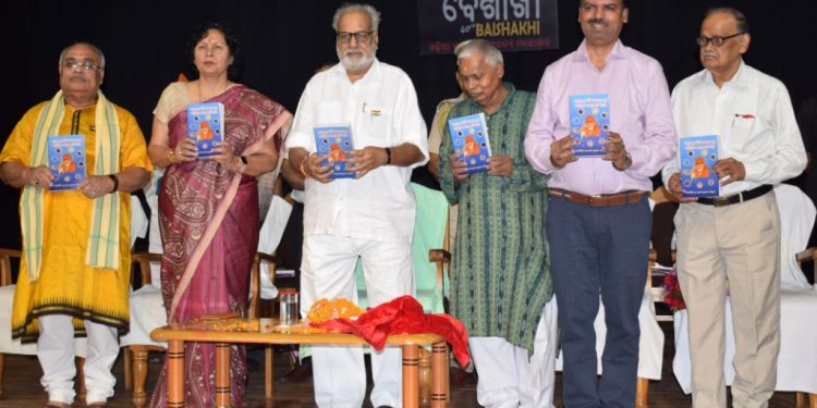 Governor Ganeshi Lal unveils a book on Shirdi Sai Baba by Pradeep Kumar Chaudhury  at Baisakhi Utsav in Bhubaneswar, Monday