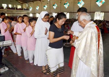 Catholic prist offers Holy Communion during the Easter Sunday Mass at the Holy church in Dimapur, Nagaland (PTI photo)