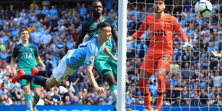 Phil Foden (airborne) of Manchester City scores his maiden Premier League goal against Tottenham Hotspur, Saturday