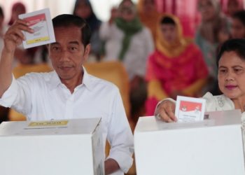 Indonesian President Joko "Jokowi" Widodo and his wife Iriana cast their ballots during the election at a polling station in Jakarta, Indonesia, Wednesday, April 17, 2019. (AP Photo/Dita Alangkara)