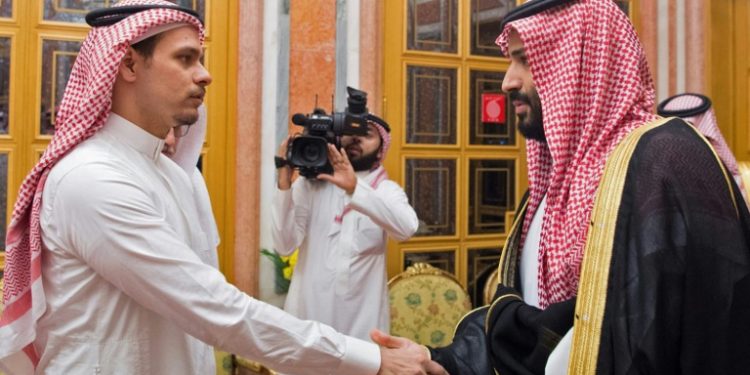 Saudi Crown Prince Mohammed bin Salman, right, shakes the hand of Salah Khashoggi, son of slain journalist Jamal Khashoggi, in Riyadh in October 2018 (AFP)