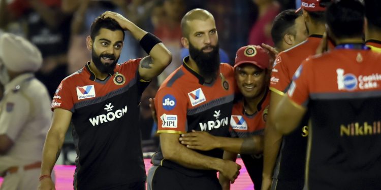 Virat Kohli (L) and his teammates celebrate after RCB's win over KXIP at Mohali, Saturday