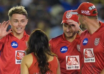 Sam Curran (L) and other KXIP players celebrate with franchise owner Preity Zinta (back to the camera) after beating Delhi Capitals, Monday