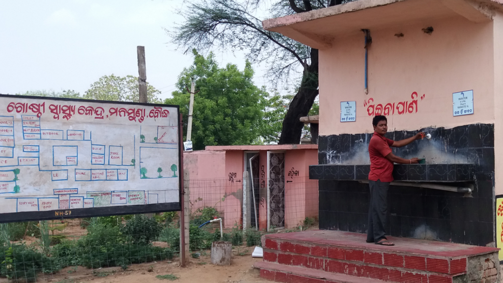 The defunct water project. An attendant opens a tap only to find that it does not work anymore