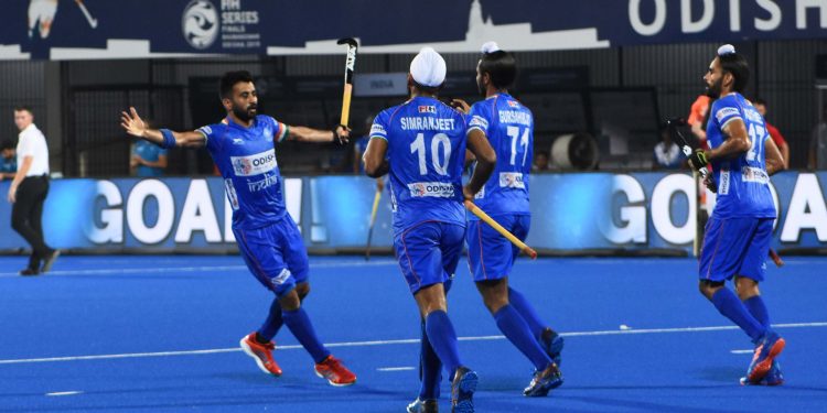 Skipper Manpreet Singh (L) celebrates with teammates after scoring against Poland at the Kalinga Stadium, Friday