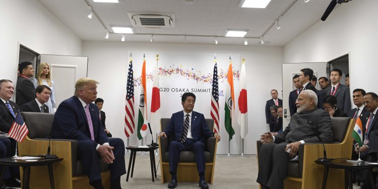 Japanese PM Shinzo Abe (c), US President Donald Trump (left) listen as Indian PM Narendra Modi speaks during the G20 summit in Osaka, Friday. Pic AP/PTI