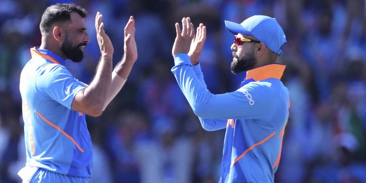 Mohammed Shami (L) celebrates with skipper Virat Kohli after dismissing a West Indian batsman, Thursday