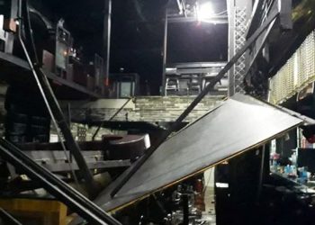 The balcony at the Coyote Ugly club close to the athletes' village was a mangled wreck after it gave way and plummeted around five metres (16 feet) onto people below.