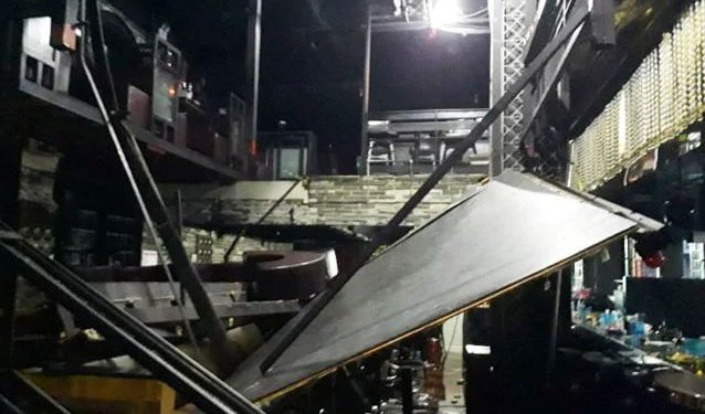 The balcony at the Coyote Ugly club close to the athletes' village was a mangled wreck after it gave way and plummeted around five metres (16 feet) onto people below.