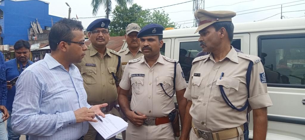 Police personnel and other officials discuss security measures in Baripada, Sunday