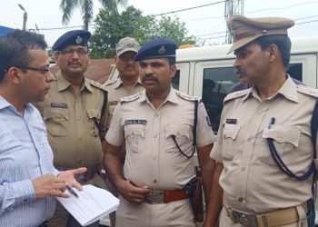 Police personnel and other officials discuss security measures in Baripada, Sunday