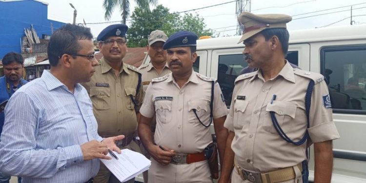 Police personnel and other officials discuss security measures in Baripada, Sunday