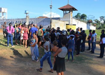 People seek information about family members who are prisoners after a riot inside the Regional Recovery Center in Altamira, Brazil, Monday, July 29, 2019. At least 57 prisoners were killed by other inmates during clashes between organized crime groups in the Altamira prison in northern Brazil Monday with 16 of the victims being decapitated, according to prison officials. (Wilson Soares/Panamazonica via AP)