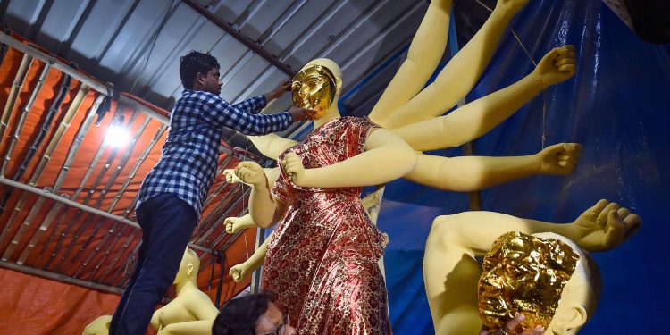 Finish touches being given to an idol of Goddess Durga