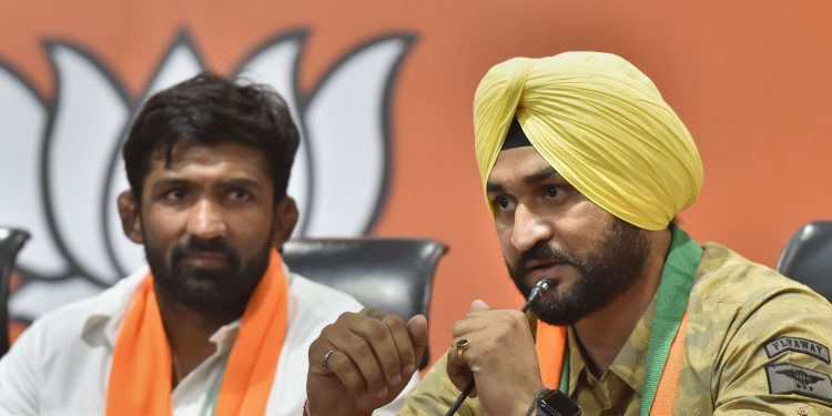 Former Indian hockey team captain Sandeep Singh and Olympic medallist wrestler Yogeshwar Dutt talks to the media after joining the BJP, Thursday