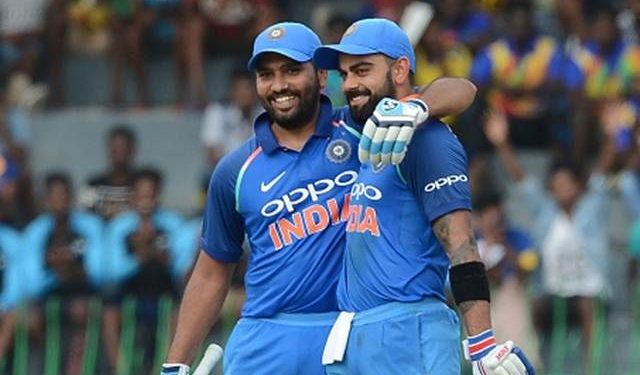 Indian cricket captain Virat Kohli (R) is congratulated by his teammate Rohit Sharma after scoring a century (100 runs) during the fourth one day international (ODI) cricket match between Sri Lanka and India at R. Premadasa Stadium in Colombo on August 31, 2017. / AFP PHOTO / LAKRUWAN WANNIARACHCHI        (Photo credit should read LAKRUWAN WANNIARACHCHI/AFP/Getty Images)