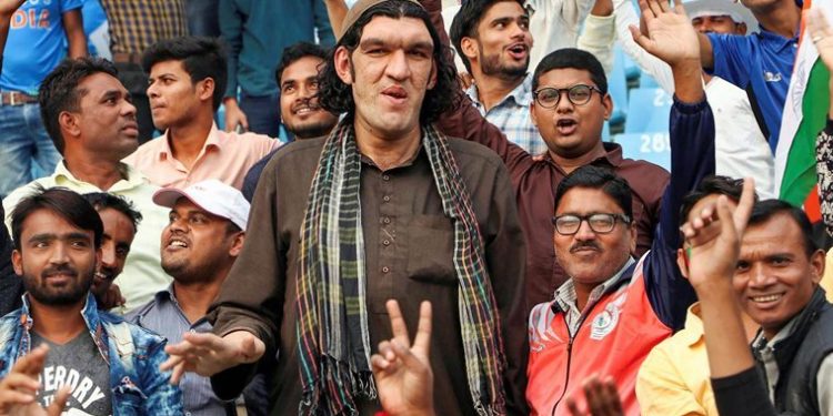 8-feet tall Afghan cricket fan Sher Khan watches the one-day international cricket series between Afghanistan and West Indies, in Lucknow, Wednesday, Nov. 6, 2019. (PTI Photo) 