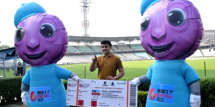 BCCI president Sourav Ganguly poses with the ticket and the mascots for the first pink ball Test in India at the Eden Gardens