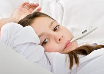 young girl lying in bed with a thermometer; Shutterstock ID 20185498; PO: today-parents