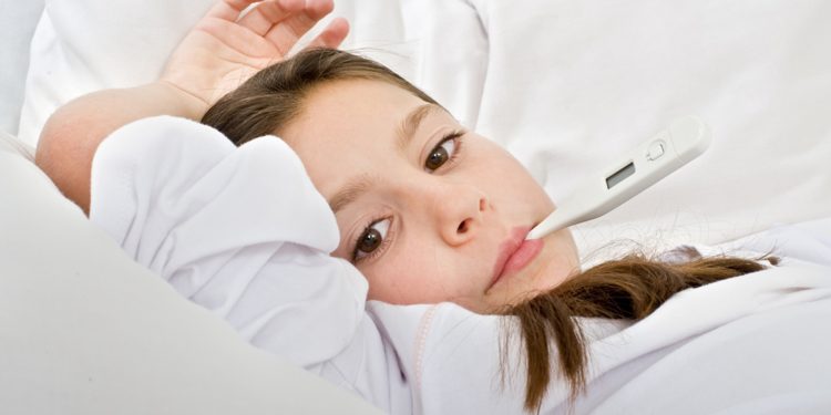 young girl lying in bed with a thermometer; Shutterstock ID 20185498; PO: today-parents