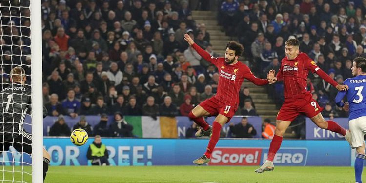 Roberto Firmino (middle) scores Liverpool's first goal with a header against Leicester City