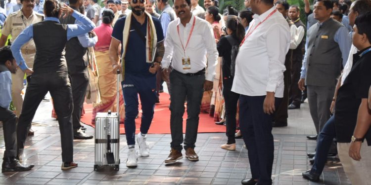 Virat Kohli being escorted into the hotel.